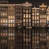 Typical-Amsterdam-houses-along-canal-at-night